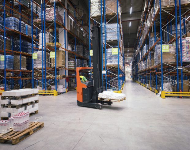Industrial building large warehouse interior with forklift and palette with goods and shelves.